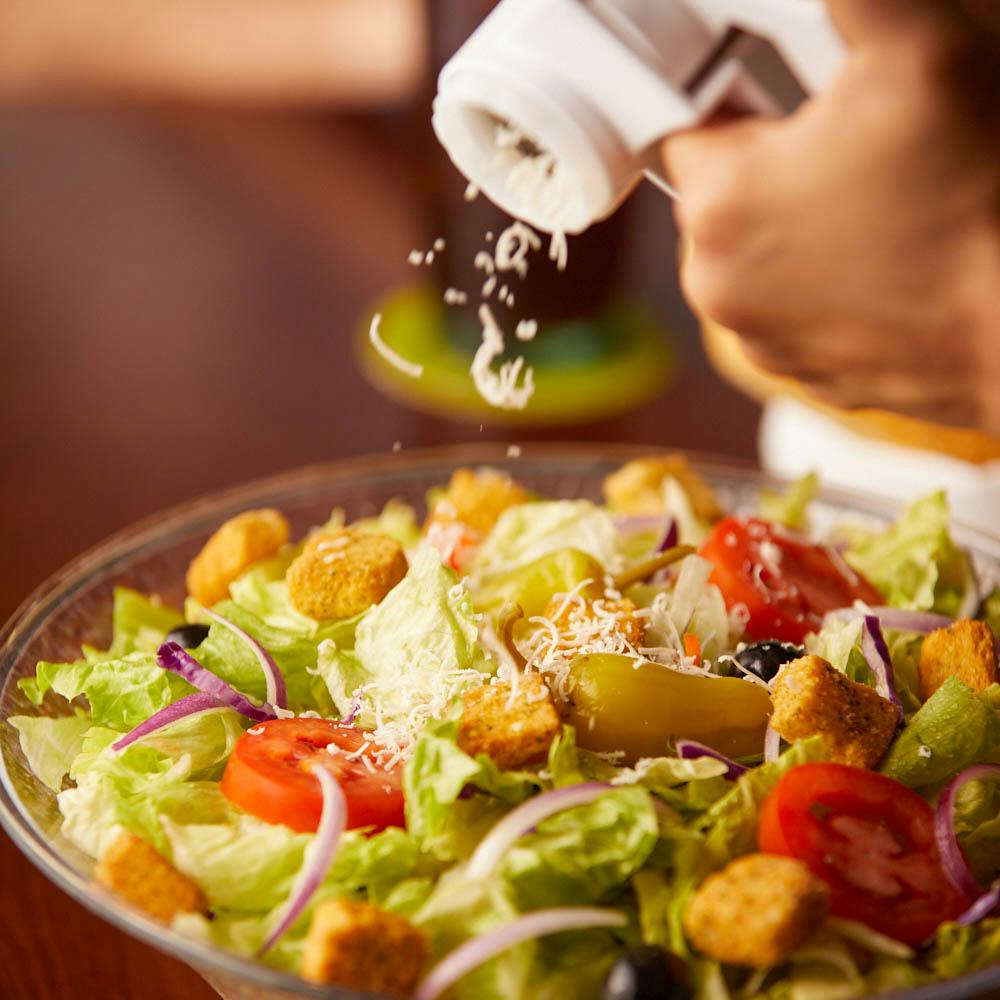 Some Salad. Some Salad or any. The child fills the Salad with Oil.