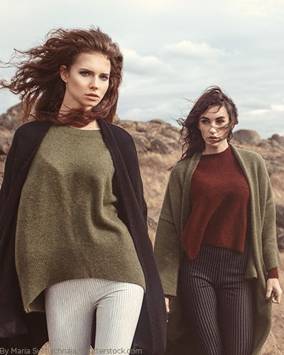 Two young woman wearing long sleeve cardigans over shirts